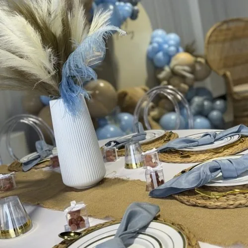 Blue napkins, pampas grass and charger plates on a styled guest table at Event Center Miami