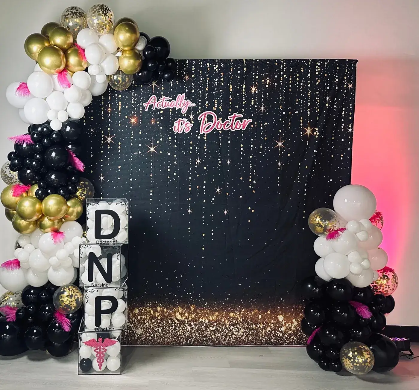 Black and gold sequin backdrop with balloon garland set up for a doctorate graduation party at Event Center Miami