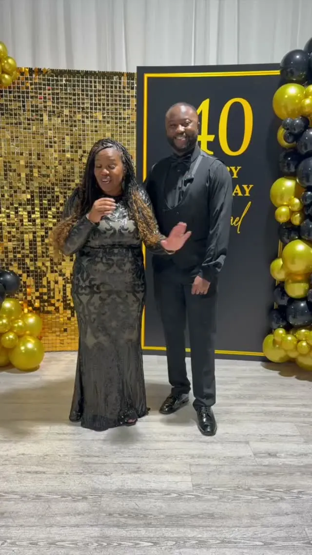 Gold and black 40th birthday balloon backdrop with marquee numbers