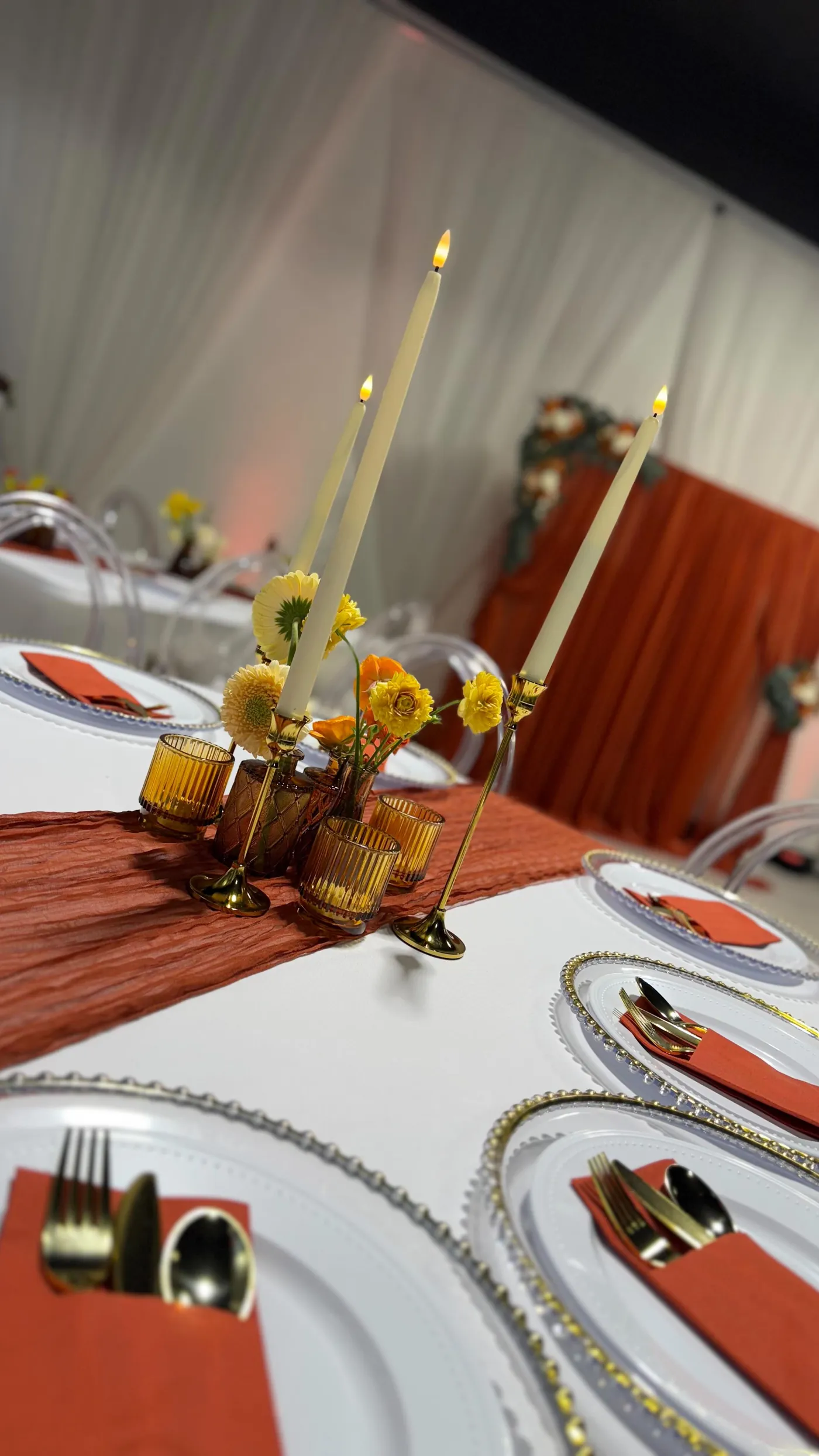Candlelit tablescape with taper candles and gold flatware