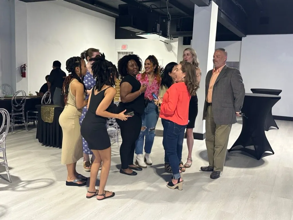 Guests mingling at a networking event inside the Event Center Miami showroom